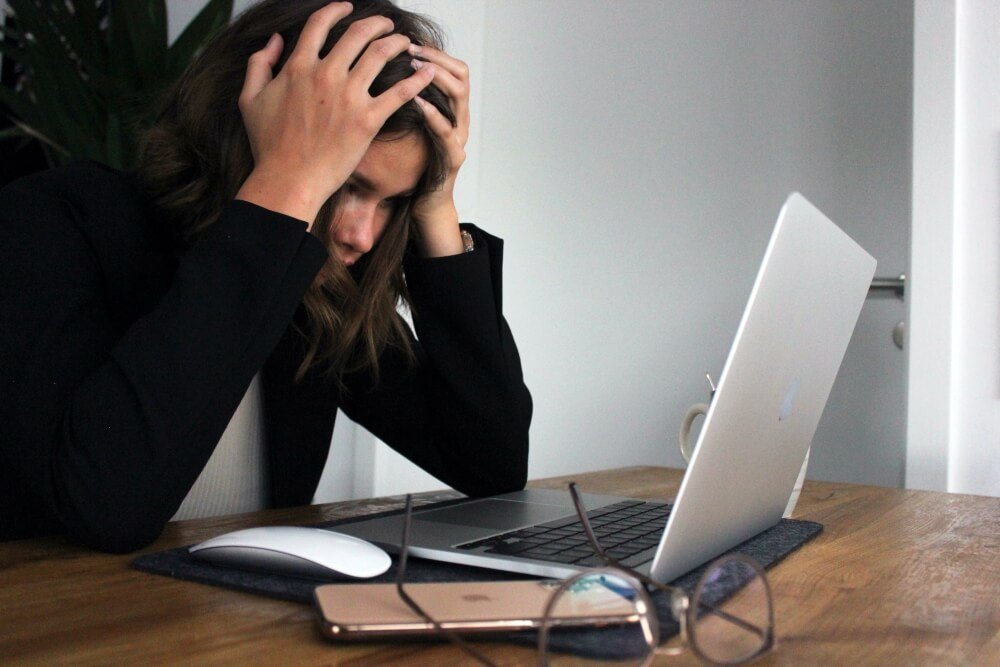 Stressed out woman in front of a laptop 